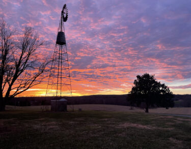 Windmill with sunset in the background.